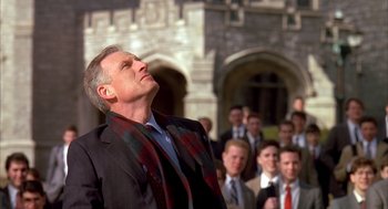 Movie still from “Scent of a Woman” (1992), directed by Martin Brest – A group of people standing around a man with his eyes closed; Medium shot, Low angle