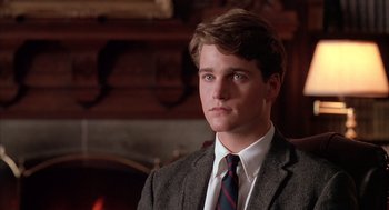 Movie still from “Scent of a Woman” (1992), directed by Martin Brest – A man in a suit and tie in front of a fire place; Close Up shot, Over the shoulder angle