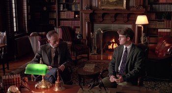 Movie still from “Scent of a Woman” (1992), directed by Martin Brest – Two men sitting in front of a fire place talking to each other; Medium shot, High angle