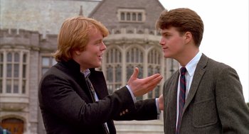 Movie still from “Scent of a Woman” (1992), directed by Martin Brest – Two young men in business attire talking to each other; Medium shot, Over the shoulder angle