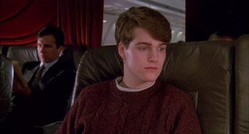 Movie still from “Scent of a Woman” (1992), directed by Martin Brest – A man sitting in a chair on top of an airplane; Close Up shot, Over the shoulder angle