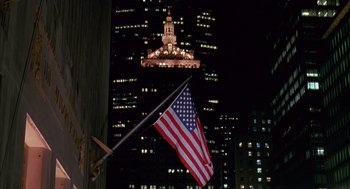 Movie still from “Scent of a Woman” (1992), directed by Martin Brest – An american flag hanging in front of a building at night; Extreme Wide shot, Low angle