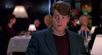 Movie still from “Scent of a Woman” (1992), directed by Martin Brest – A young man in a jacket and sweater looks to his left; Close Up shot, Over the shoulder angle