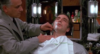Movie still from “Scent of a Woman” (1992), directed by Martin Brest – A man getting a shave from a barber; Close Up shot, Low angle