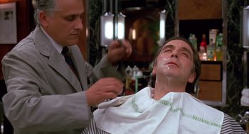 Movie still from “Scent of a Woman” (1992), directed by Martin Brest – A man getting his hair cut at a barber shop; Close Up shot, Low angle