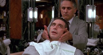 Movie still from “Scent of a Woman” (1992), directed by Martin Brest – A man getting his hair cut in a barber shop; Close Up shot, Over the shoulder angle
