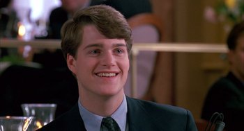 Movie still from “Scent of a Woman” (1992), directed by Martin Brest – A man in a suit and tie smiling for the camera; Close Up shot, Low angle