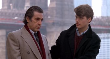 Movie still from “Scent of a Woman” (1992), directed by Martin Brest – A man and a young man standing next to each other; Medium shot, Over the shoulder angle