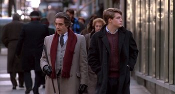 Movie still from “Scent of a Woman” (1992), directed by Martin Brest – Two men walking down the street in the winter; Medium shot, Over the shoulder angle