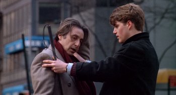 Movie still from “Scent of a Woman” (1992), directed by Martin Brest – A young man holding an umbrella over an older man's shoulder; Medium shot, Over the shoulder angle
