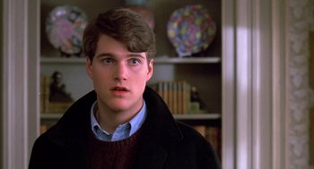 Movie still from “Scent of a Woman” (1992), directed by Martin Brest – A young man in a sweater and a black coat; Close Up shot, Over the shoulder angle