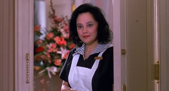Movie still from “Scent of a Woman” (1992), directed by Martin Brest – A woman standing in front of a door wearing an apron; Close Up shot, Low angle