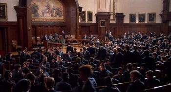 Movie still from “Scent of a Woman” (1992), directed by Martin Brest – A group of people in suits sitting in a courtroom; Extreme Wide shot, High angle