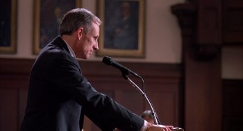 Movie still from “Scent of a Woman” (1992), directed by Martin Brest – A man in a black suit is speaking at a podium; Medium shot, Low angle