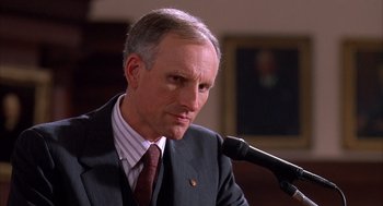 Movie still from “Scent of a Woman” (1992), directed by Martin Brest – A person wearing a suit holding a microphone; Close Up shot, Low angle