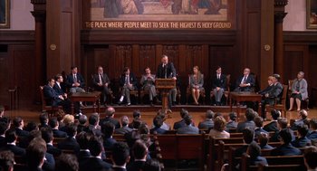 Movie still from “Scent of a Woman” (1992), directed by Martin Brest – A group of people sitting in front of a podium; Wide shot, High angle