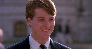 Movie still from “Scent of a Woman” (1992), directed by Martin Brest – A man in a suit and tie smiling for the camera; Close Up shot, Low angle