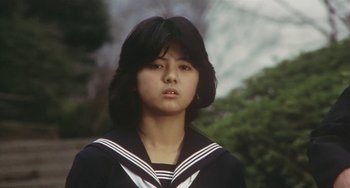 Movie still from “School in the Crosshairs” (1981), directed by Nobuhiko Ôbayashi – A young woman in a sailor's uniform; Close Up shot, Low angle