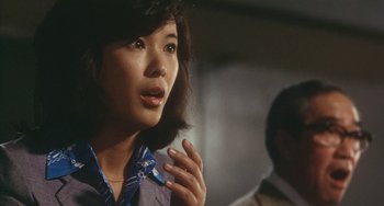 Movie still from “School in the Crosshairs” (1981), directed by Nobuhiko Ôbayashi – A woman is talking to someone in a room; Close Up shot, Over the shoulder angle