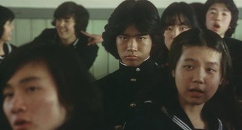 Movie still from “School in the Crosshairs” (1981), directed by Nobuhiko Ôbayashi – A group of young people standing in front of a mirror; Medium shot, Low angle