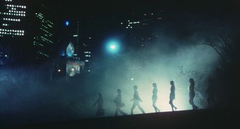 Movie still from “School in the Crosshairs” (1981), directed by Nobuhiko Ôbayashi – A group of people walking in the fog at night; Extreme Wide shot, Low angle