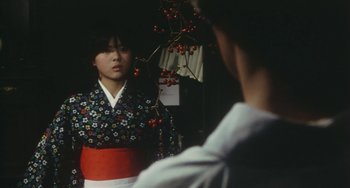 Movie still from “School in the Crosshairs” (1981), directed by Nobuhiko Ôbayashi – A woman in a kimono looking in a mirror; Medium shot, Over the shoulder angle