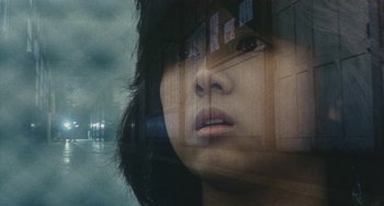 Movie still from “School in the Crosshairs” (1981), directed by Nobuhiko Ôbayashi – A woman's face in a glass window; Close Up shot, Low angle