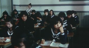Movie still from “School in the Crosshairs” (1981), directed by Nobuhiko Ôbayashi – A group of people sitting at a table in a classroom; Medium shot, High angle