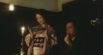 Movie still from “School in the Crosshairs” (1981), directed by Nobuhiko Ôbayashi – A man and a woman in traditional japanese garb; Medium shot, Low angle