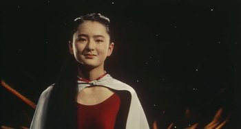 Movie still from “School in the Crosshairs” (1981), directed by Nobuhiko Ôbayashi – A woman in a red and white dress; Medium shot, Low angle