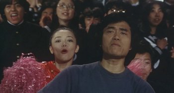 Movie still from “School in the Crosshairs” (1981), directed by Nobuhiko Ôbayashi – A group of people sitting in front of each other; Close Up shot, Low angle