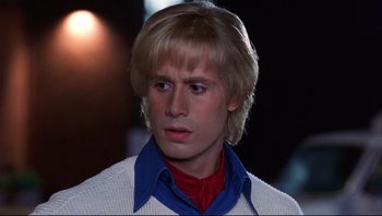 Movie still from “Scooby-Doo” (2002), directed by Raja Gosnell – A man with blonde hair wearing a white sweater; Close Up shot, Low angle