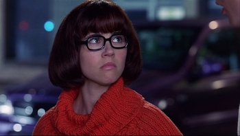 Movie still from “Scooby-Doo” (2002), directed by Raja Gosnell – A woman wearing glasses and a red sweater looking to her left; Close Up shot, Over the shoulder angle