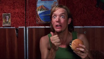 Movie still from “Scooby-Doo” (2002), directed by Raja Gosnell – A man holding a hamburger in front of him; Close Up shot, Overhead angle