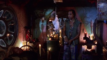 Movie still from “Scooby-Doo” (2002), directed by Raja Gosnell – A man standing next to candles in a dark room; Medium shot, Low angle