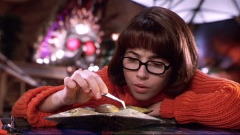 Movie still from “Scooby-Doo” (2002), directed by Raja Gosnell – A woman in a red sweater is eating food; Close Up shot, Low angle
