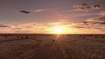 Movie still from “Scooby-Doo” (2002), directed by Raja Gosnell – A car driving down a dirt road at sunset; Extreme Wide shot, High angle
