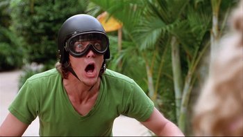Movie still from “Scooby-Doo” (2002), directed by Raja Gosnell – A man riding a bike wearing a helmet and goggles; Close Up shot, Low angle