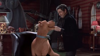 Movie still from “Scooby-Doo” (2002), directed by Raja Gosnell – A man in black jacket with a brown dog; Medium shot, Over the shoulder angle