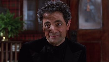 Movie still from “Scooby-Doo” (2002), directed by Raja Gosnell – A person with curly hair wearing a suit; Close Up shot, Over the shoulder angle