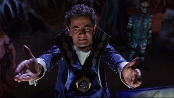 Movie still from “Scooby-Doo” (2002), directed by Raja Gosnell – A man in a blue suit is standing in the dark; Medium shot, Low angle