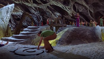 Movie still from “Scooby-Doo” (2002), directed by Raja Gosnell – A man kneeling on the ground in front of a group of people; Extreme Wide shot, High angle