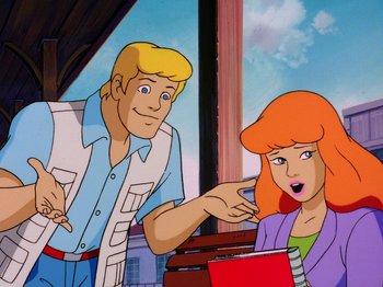 Movie still from “Scooby-Doo on Zombie Island” (1998), directed by Jim Stenstrum – A woman pointing at a man with a pen in his hand in front of a window; Medium shot, Over the shoulder angle