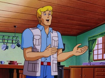 Movie still from “Scooby-Doo on Zombie Island” (1998), directed by Jim Stenstrum – A cartoon of a man standing in front of a kitchen; Medium shot, Over the shoulder angle
