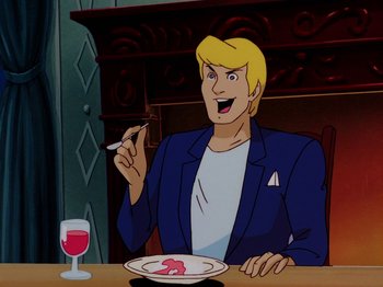 Movie still from “Scooby-Doo on Zombie Island” (1998), directed by Jim Stenstrum – A man sitting in front of a plate of food and a glass of red wine; Medium shot, Over the shoulder angle