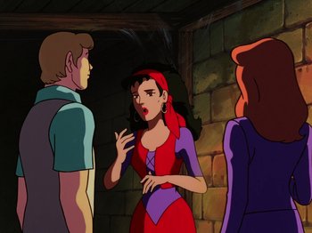 Movie still from “Scooby-Doo on Zombie Island” (1998), directed by Jim Stenstrum – A woman in a red and purple dress talking to two other people; Medium shot, Over the shoulder angle