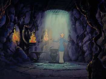 Movie still from “Scooby-Doo on Zombie Island” (1998), directed by Jim Stenstrum – A woman standing in front of a fire in a cave; Wide shot, High angle