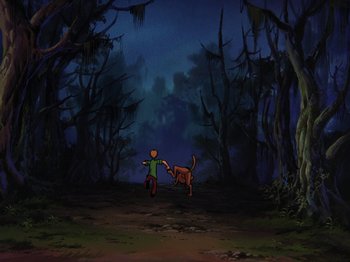 Movie still from “Scooby-Doo on Zombie Island” (1998), directed by Jim Stenstrum – A boy and a dog are walking through the woods; Extreme Wide shot, High angle