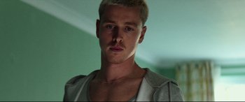 Movie still from “Scrapper” (2023), directed by Charlotte Regan – A person wearing a white shirt; Close Up shot, Low angle