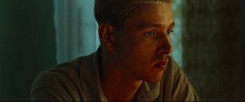 Movie still from “Scrapper” (2023), directed by Charlotte Regan – A person looking at the camera; Close Up shot, Low angle